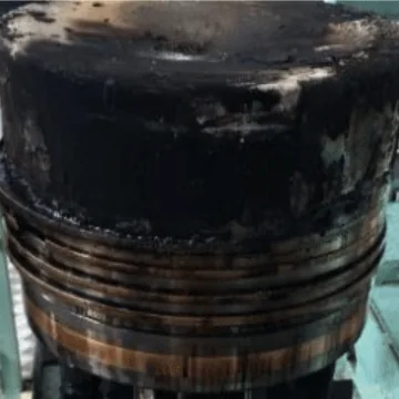 Piston covered with thick carbon deposits